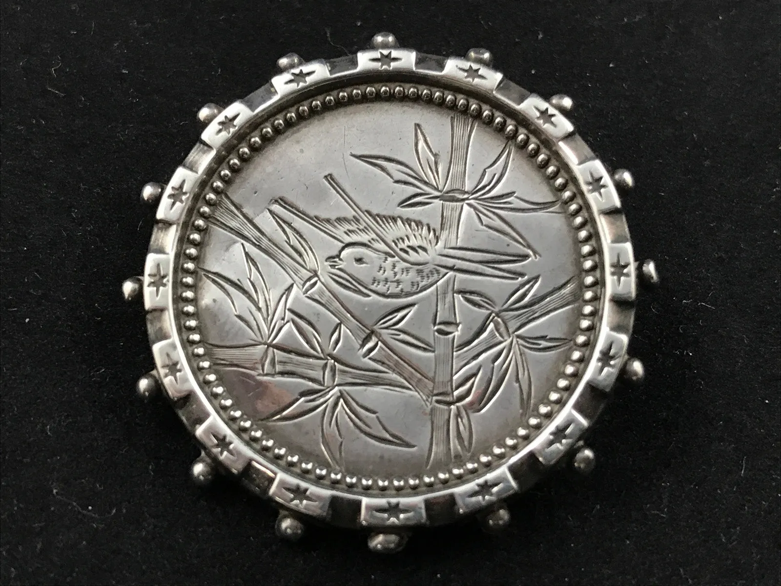 Victorian silver Aesthetic Movement brooch engraved with a bird in bamboo